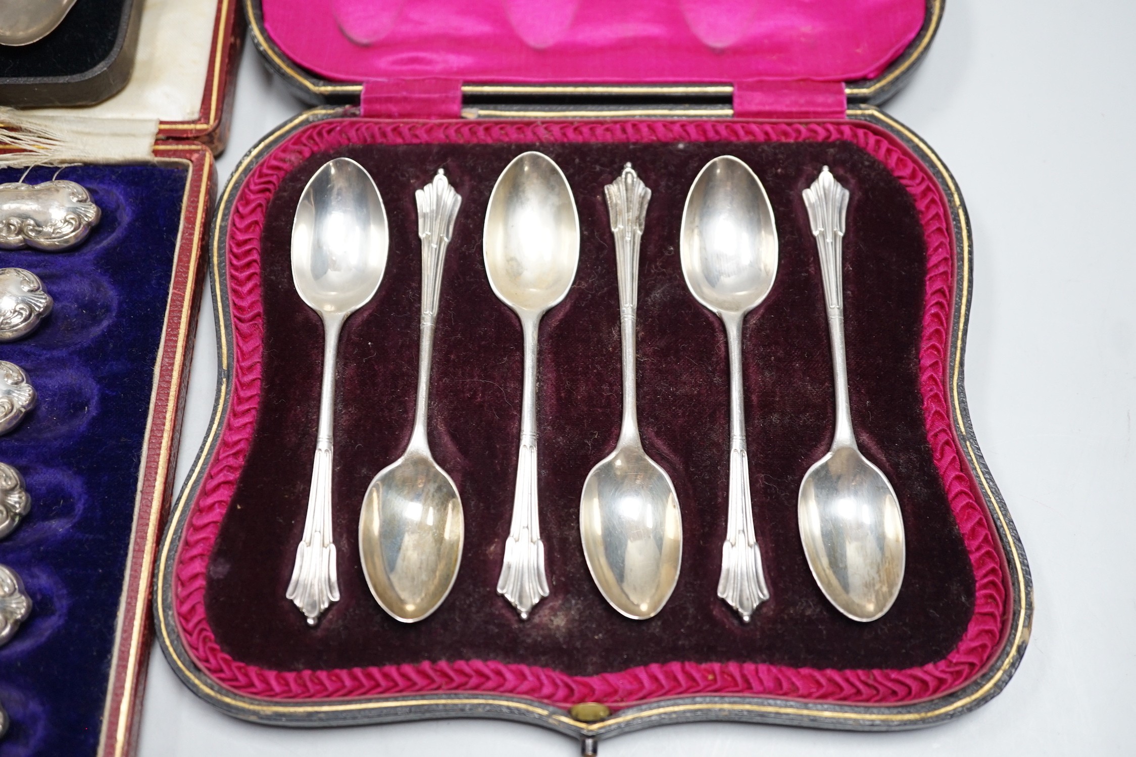 A set of six teaspoons, London, 1910, a set of six silver coffee spoons, six silver handled tea knives, all cased.